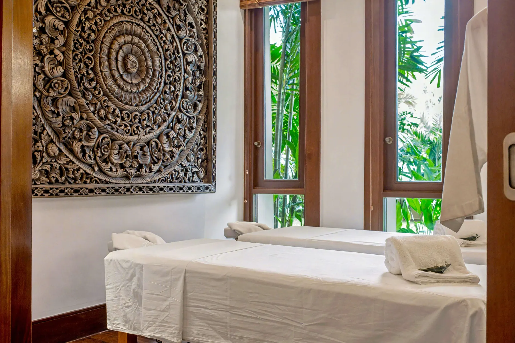 Spa treatment beds with carved panel