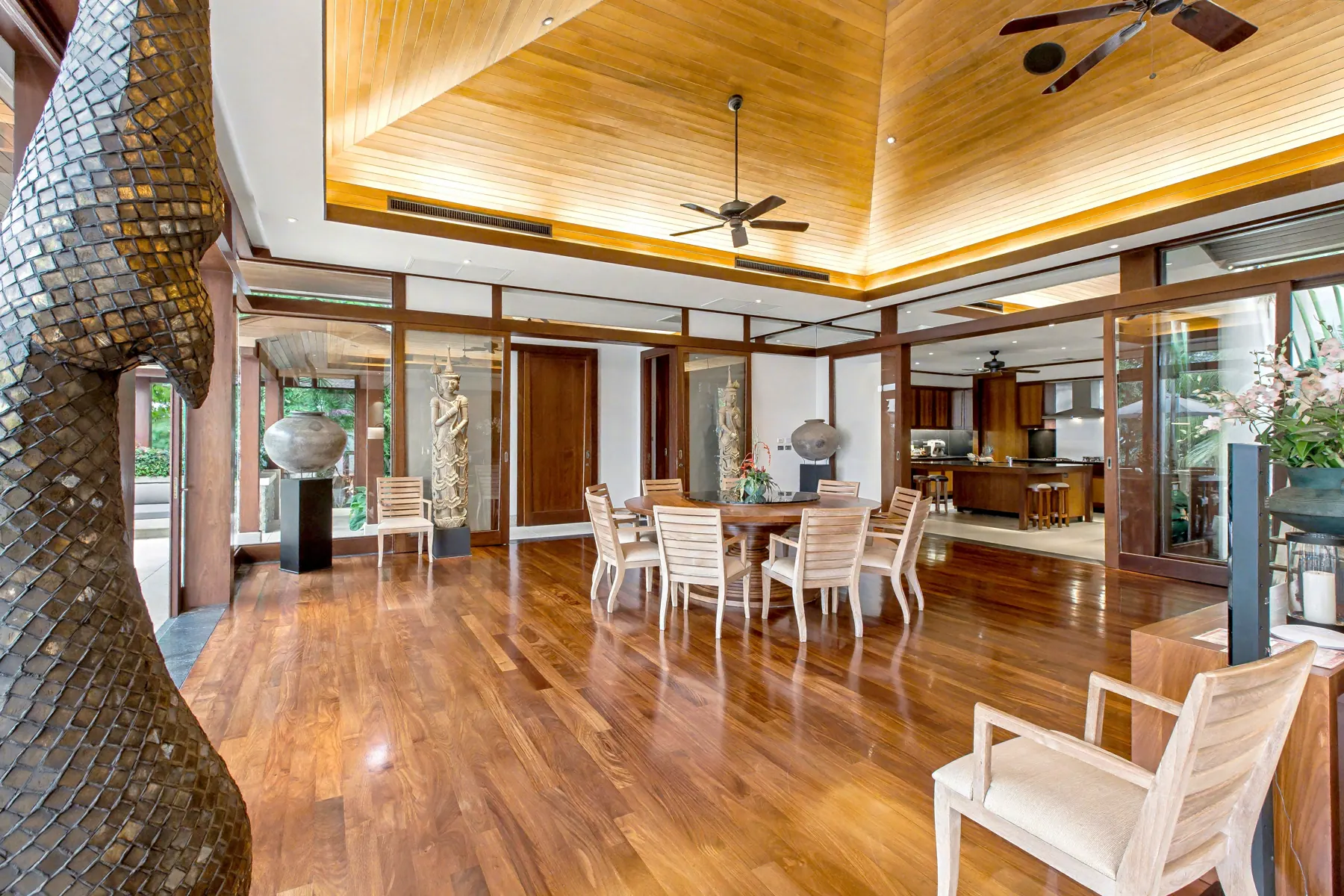 Open living and dining area with Thai sculpture