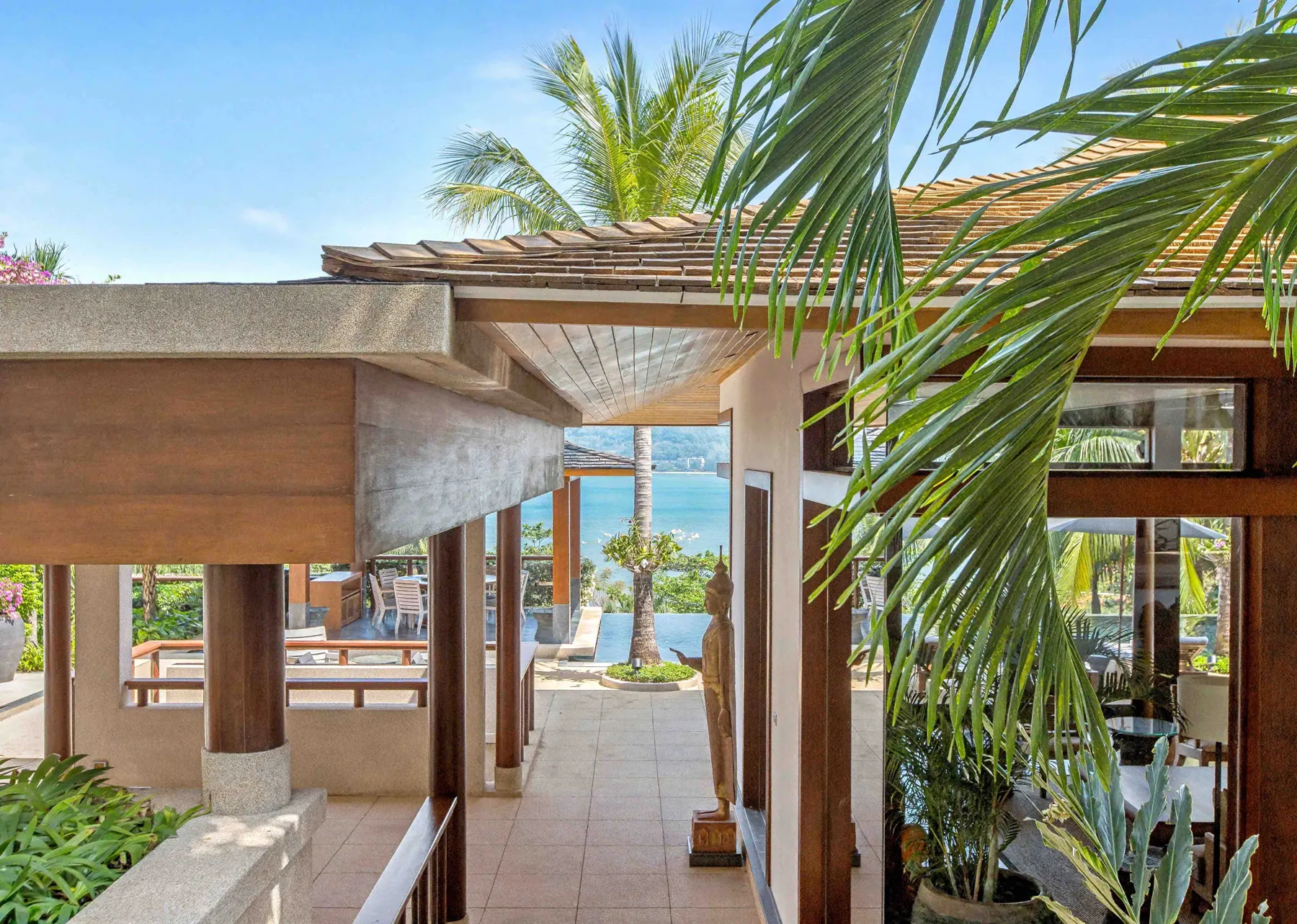 Terrace view towards the sea through tropical palms