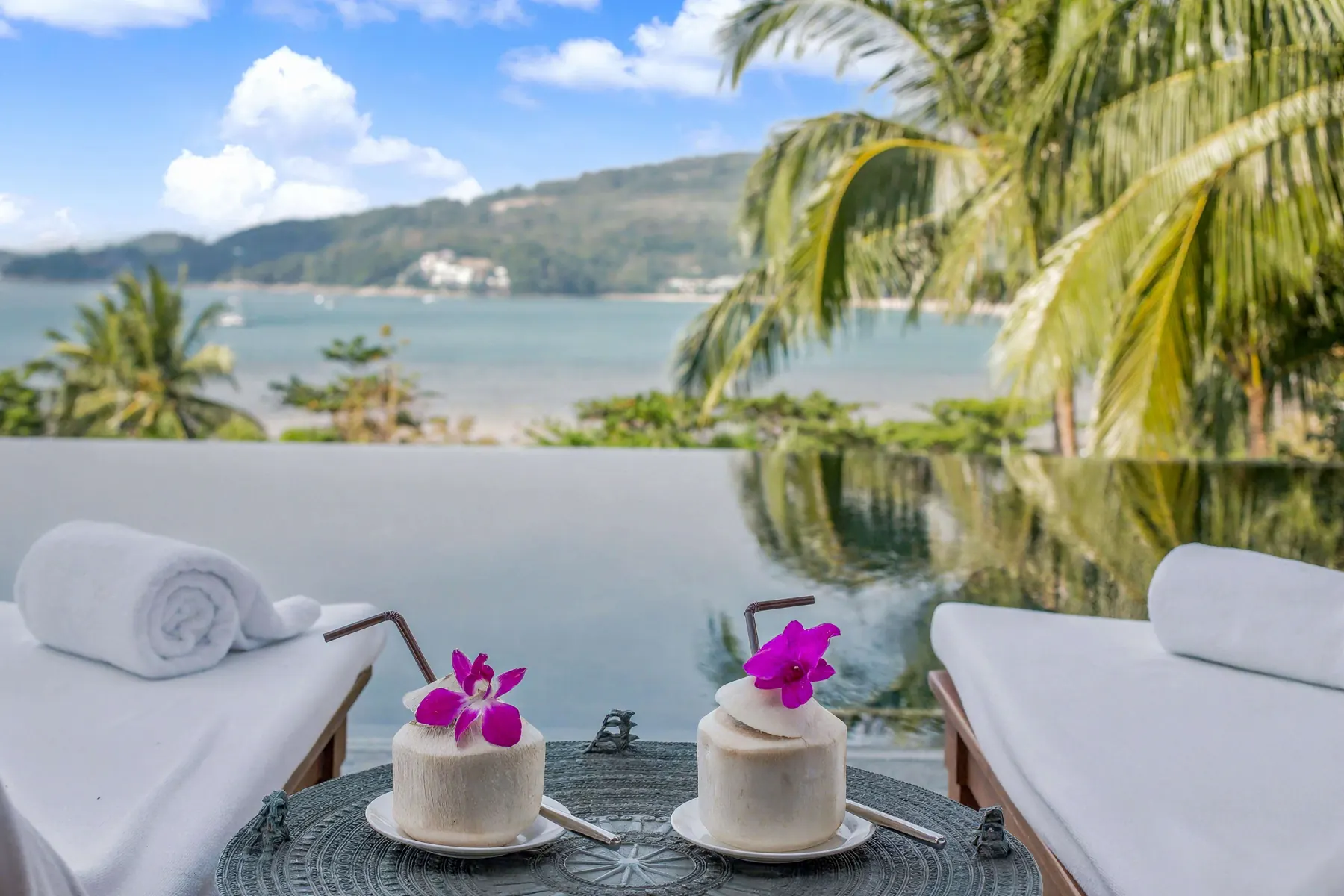 Fresh coconuts by the infinity pool overlooking Kamala Bay