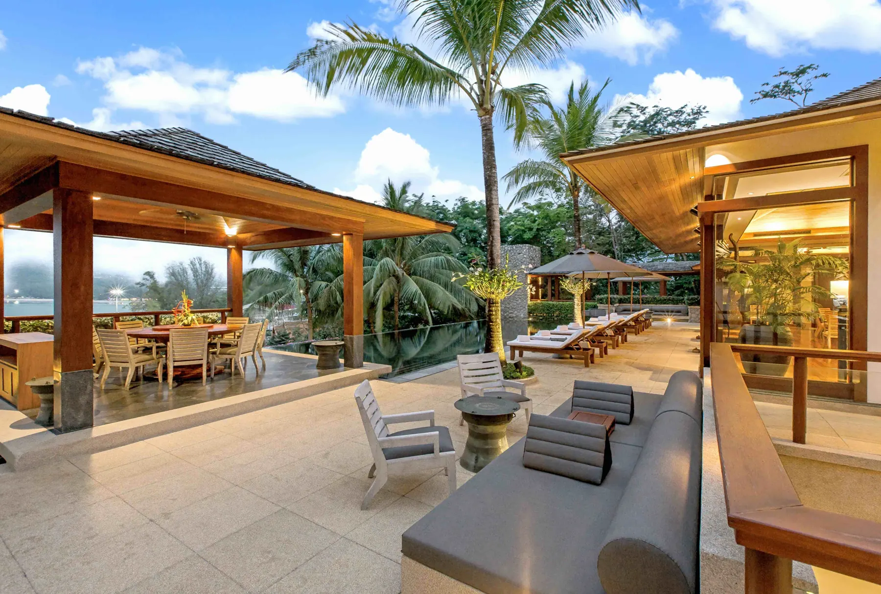 Outdoor lounge and dining sala beside the pool