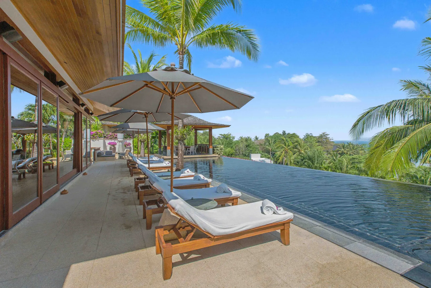 Pool terrace with umbrellas and sea view